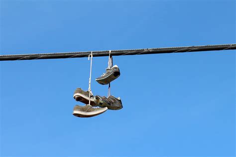 throwing shoes on power lines meaning